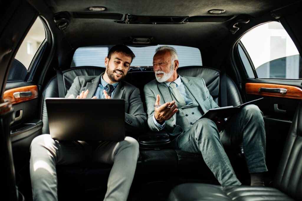 two businessmen in a car